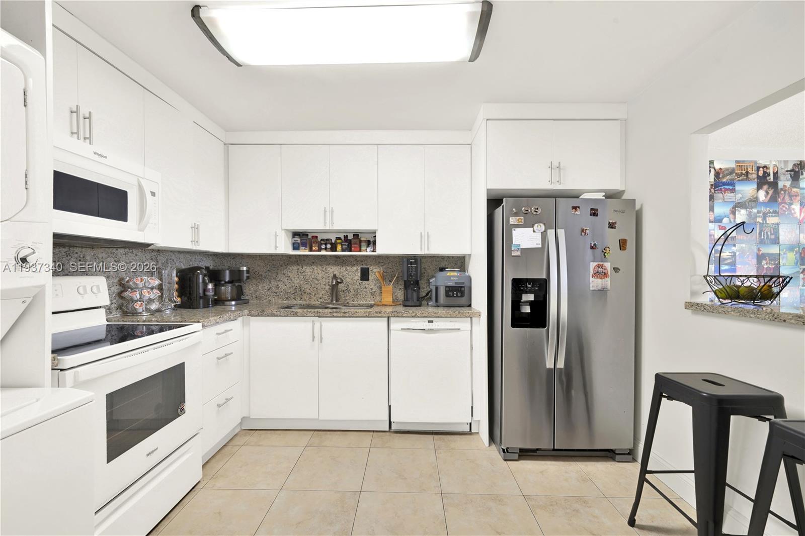 1901 Brickell Avenue, Unit B711 Miami, FL 33129 - Photo 9 of 41 a kitchen with stainless steel appliances granite countertop a refrigerator and a stove top oven