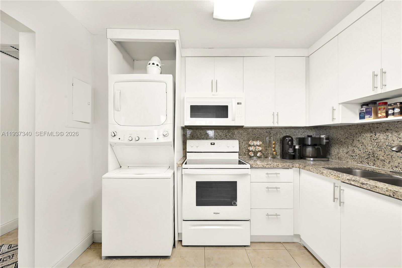 1901 Brickell Avenue, Unit B711 Miami, FL 33129 - Photo 10 of 41 a kitchen with white cabinets and white appliances