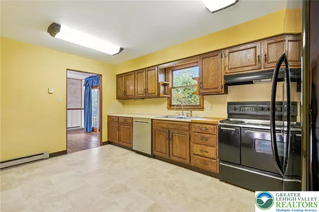 a kitchen with stainless steel appliances granite countertop a stove and a sink