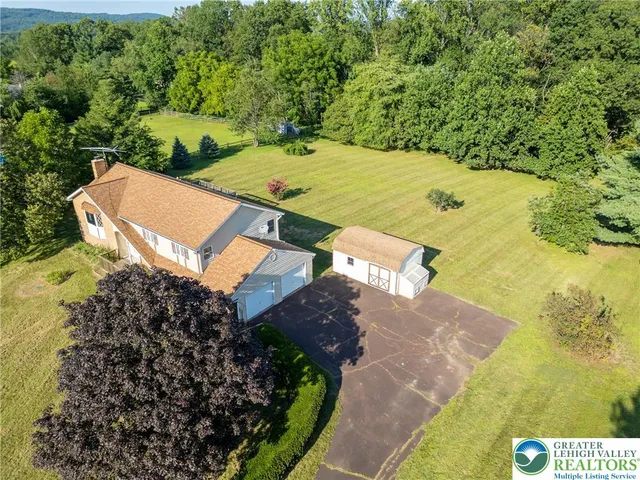an aerial view of a house with yard swimming pool and outdoor seating