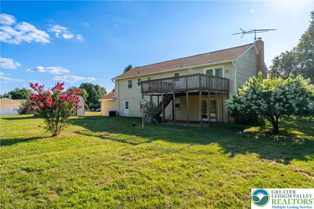 an aerial view of residential houses with outdoor space and swimming pool