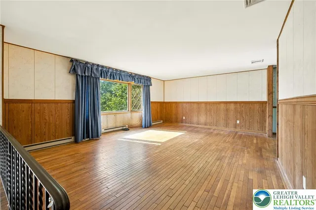 a view of a room with wooden floor and window