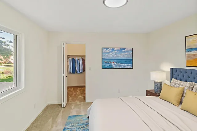 a bedroom with a large bed and a window