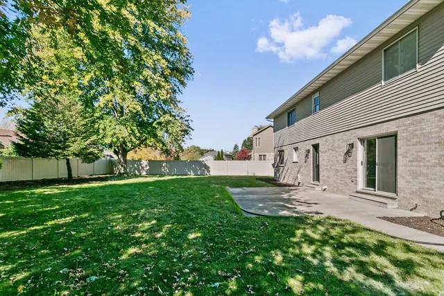 a backyard of a house with table and chairs