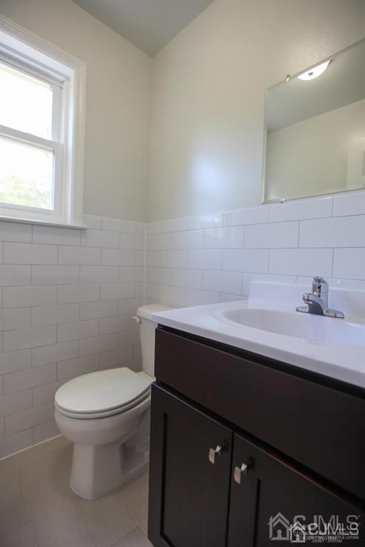 3304 Hana Road Edison, NJ 08817 - Photo 5 of 13 a bathroom with a sink a toilet and a window