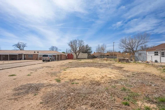 a view of the house with a yard