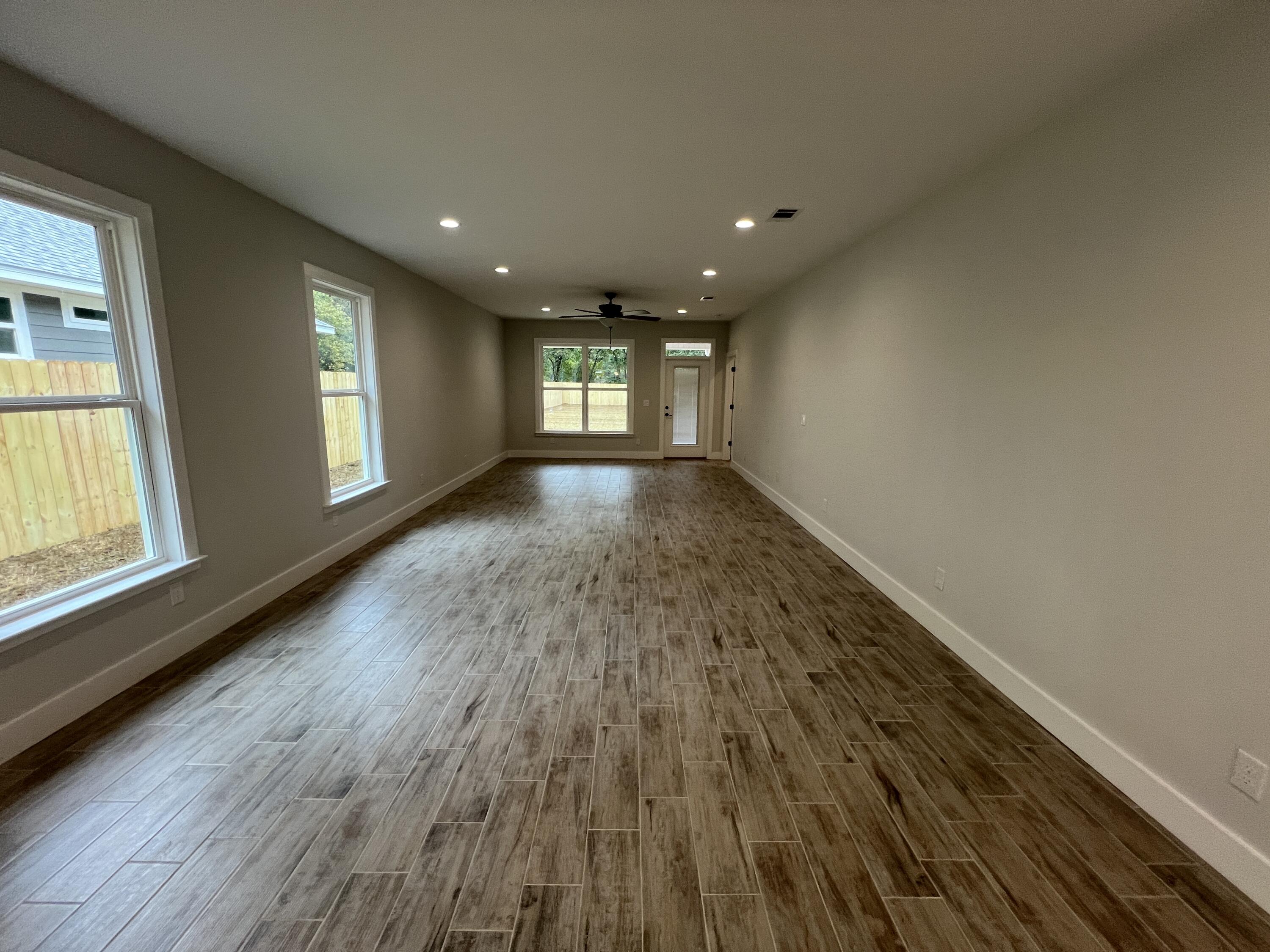 1491 Cat-Mar Road Niceville, FL 32578 - Photo 11 of 30 a view of empty room with wooden floor and fan