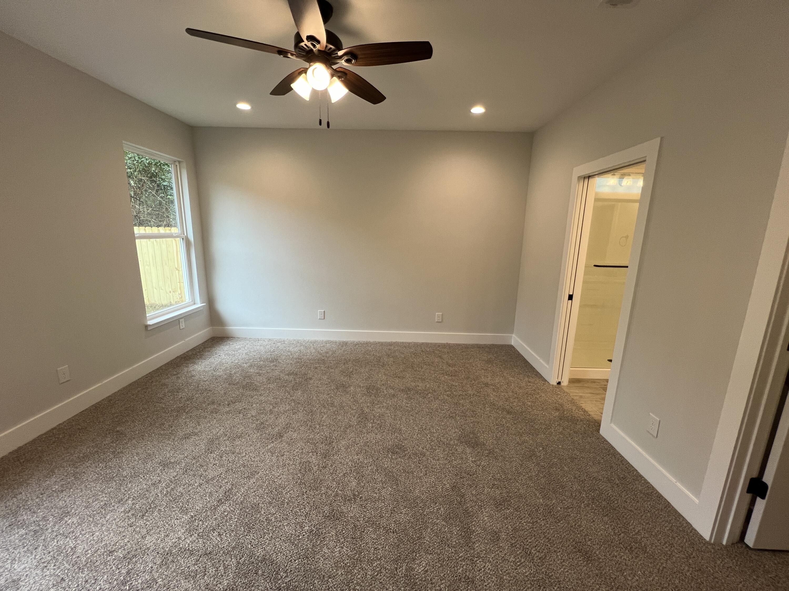 1491 Cat-Mar Road Niceville, FL 32578 - Photo 14 of 30 an empty room with windows and fan