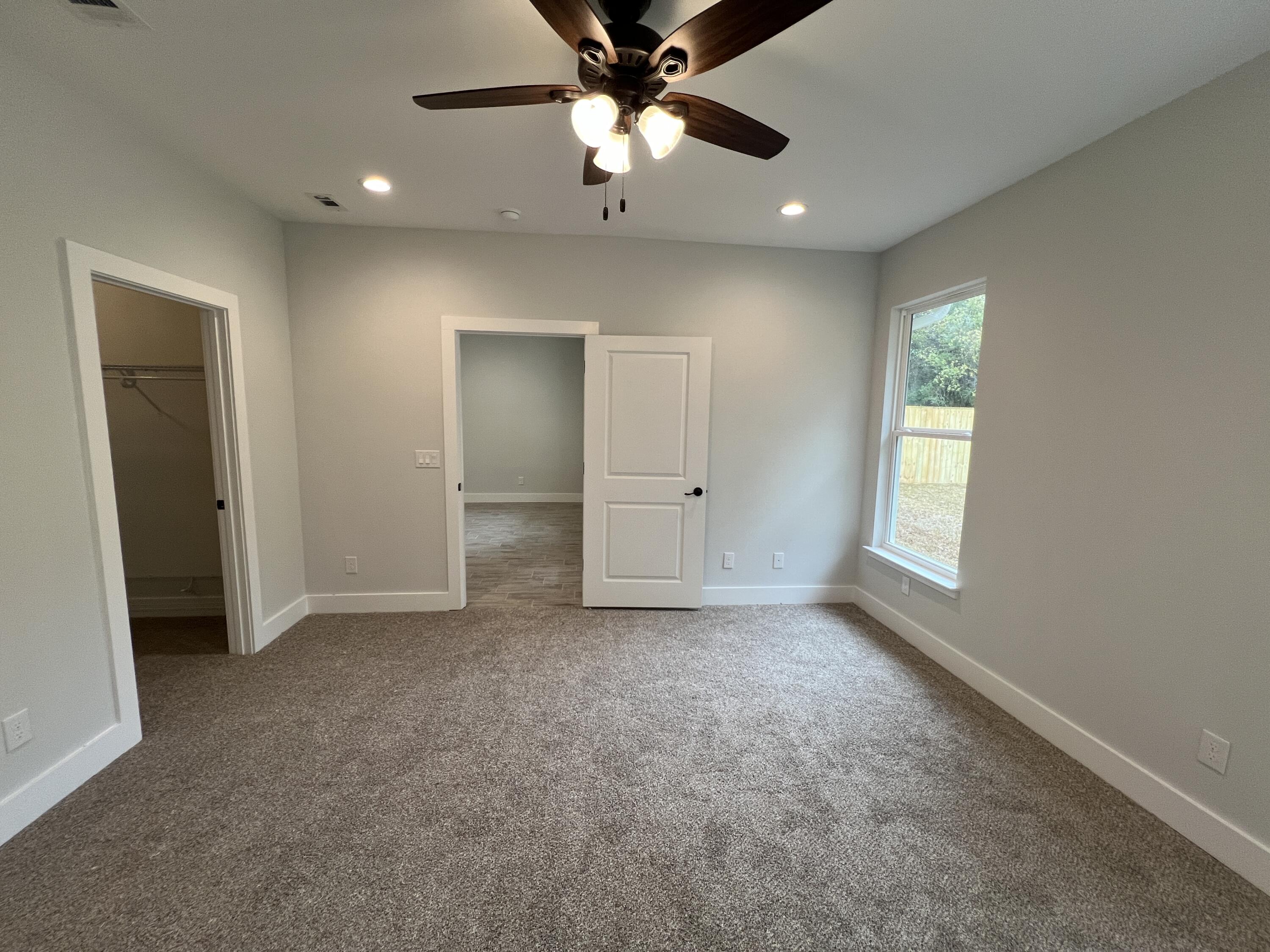 1491 Cat-Mar Road Niceville, FL 32578 - Photo 15 of 30 an empty room with closet and a ceiling fan