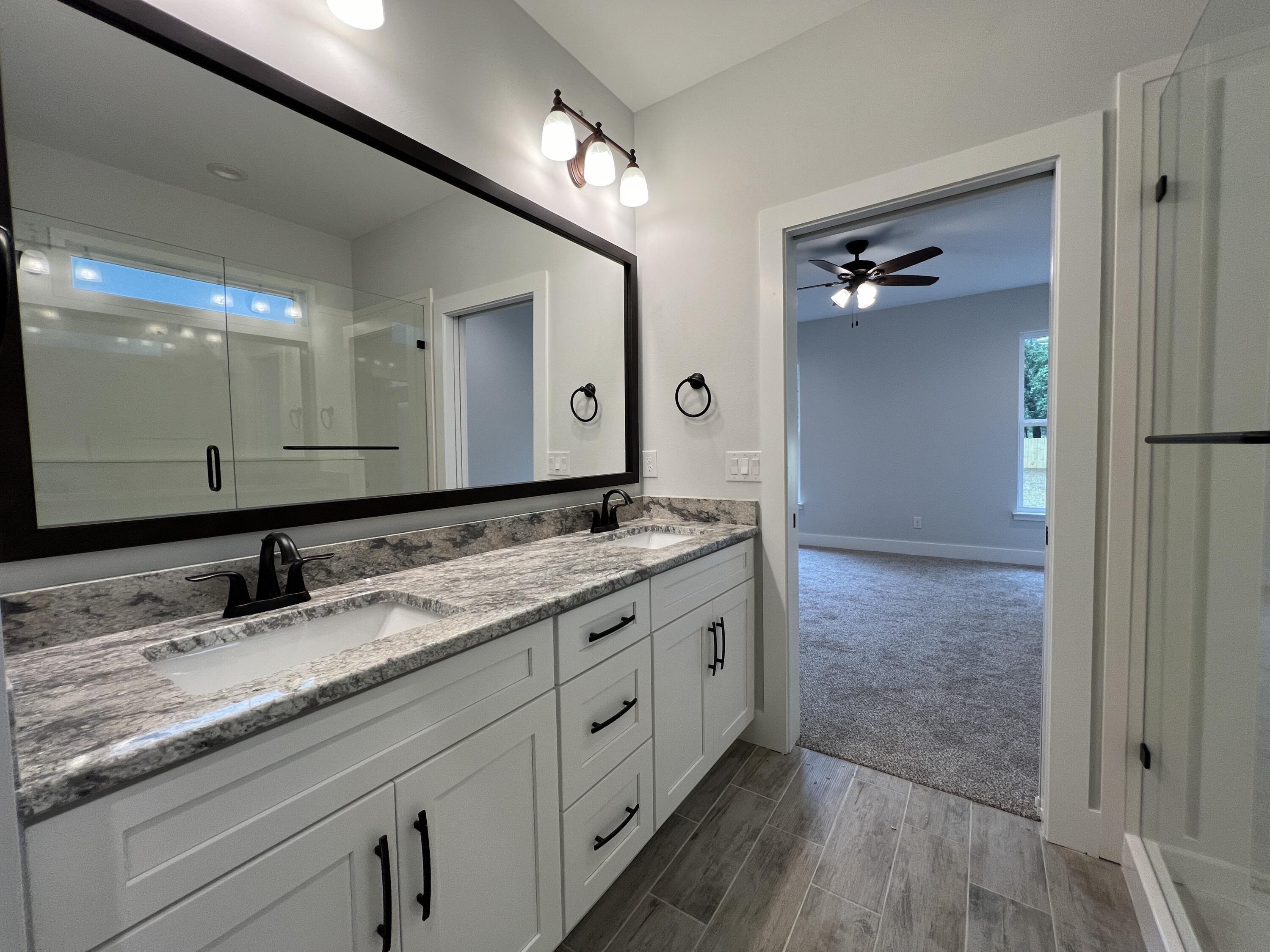 1491 Cat-Mar Road Niceville, FL 32578 - Photo 18 of 30 a bathroom with a granite countertop double vanity sink and a mirror