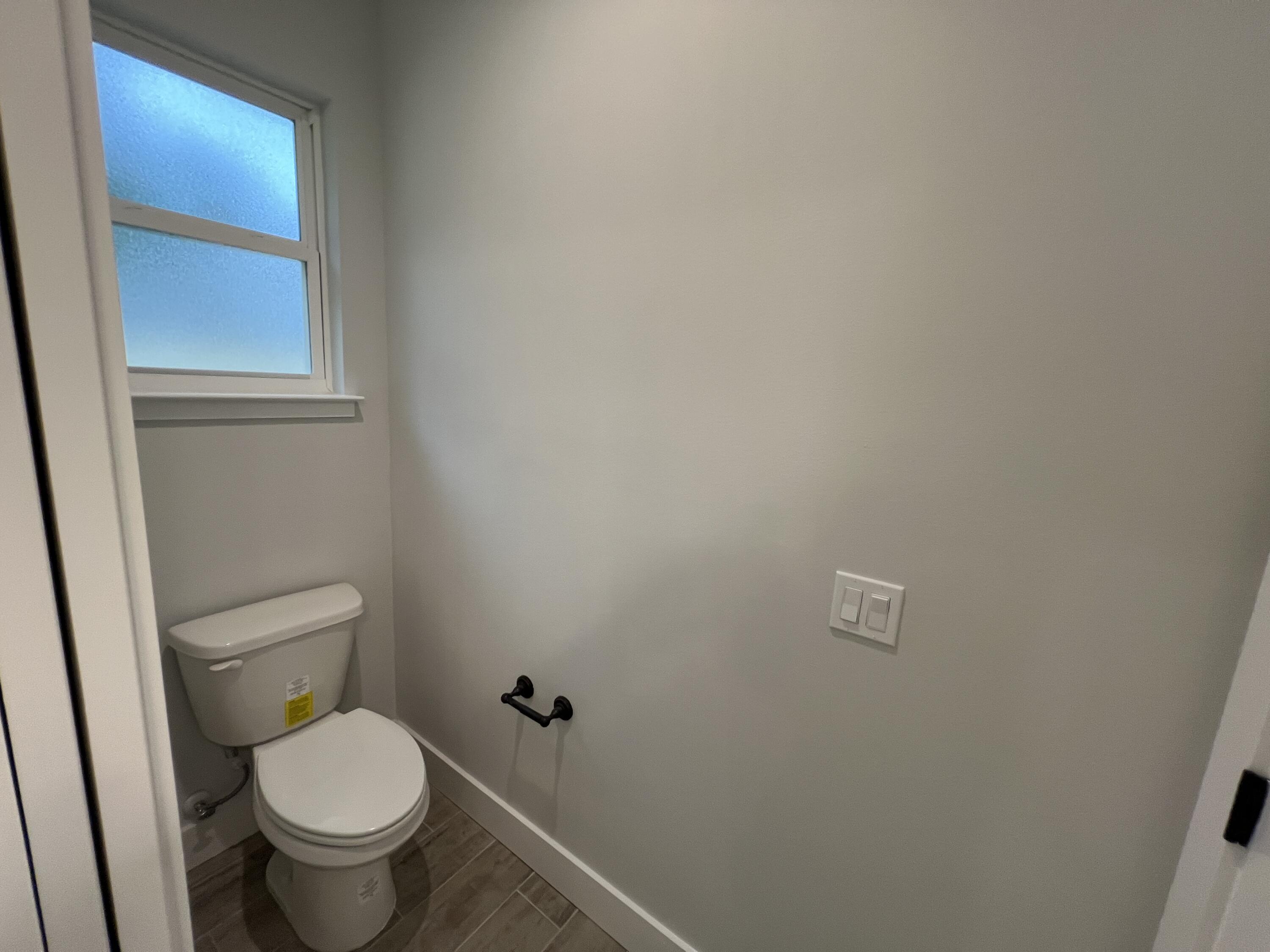 1491 Cat-Mar Road Niceville, FL 32578 - Photo 22 of 30 a white toilet sitting next to a small window