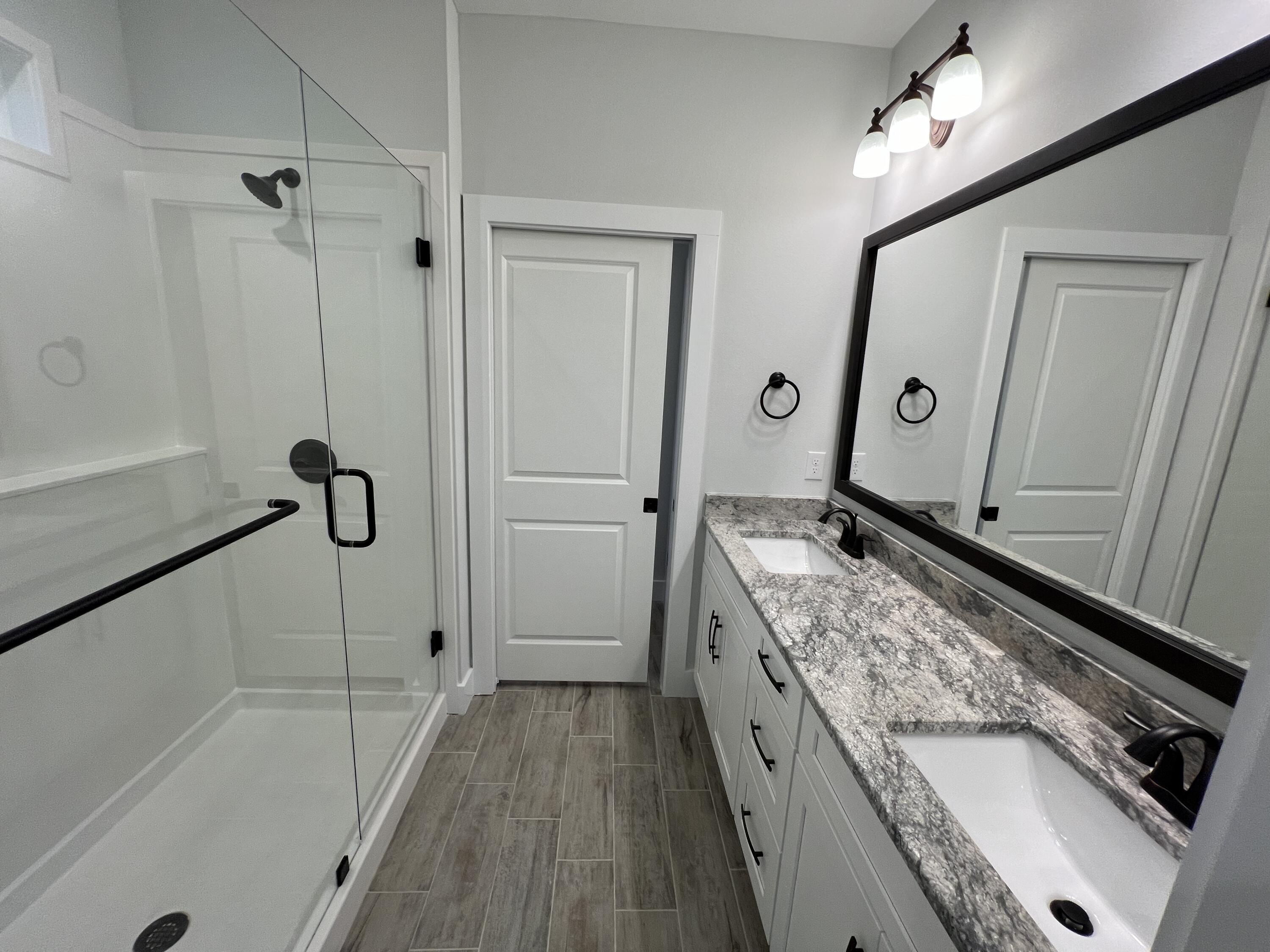 1491 Cat-Mar Road Niceville, FL 32578 - Photo 23 of 30 a bathroom with a granite countertop sink a mirror and shower