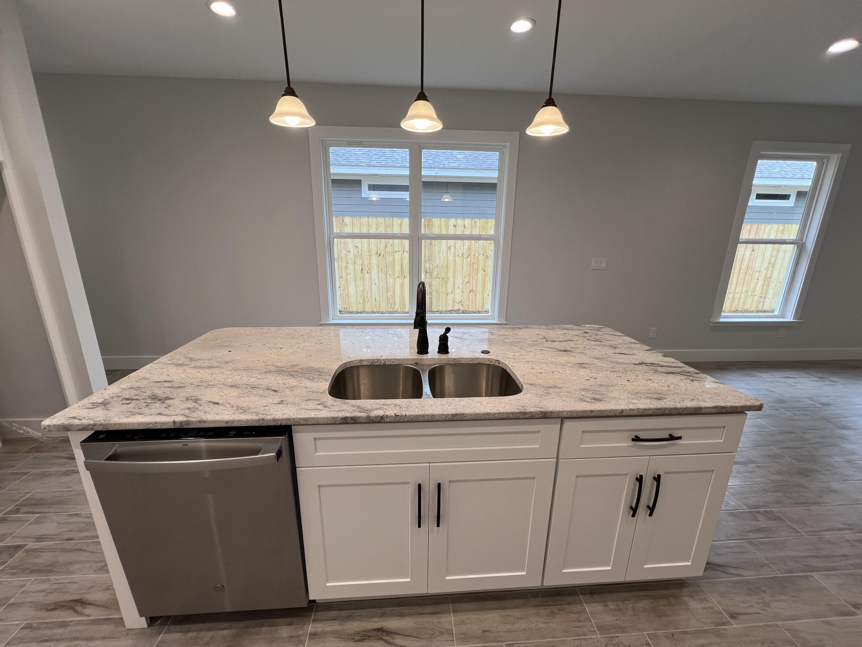 1491 Cat-Mar Road Niceville, FL 32578 - Photo 8 of 30 a kitchen with sink cabinets and window