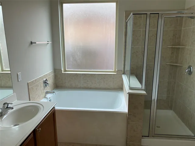 a bathroom with a bathtub and a sink