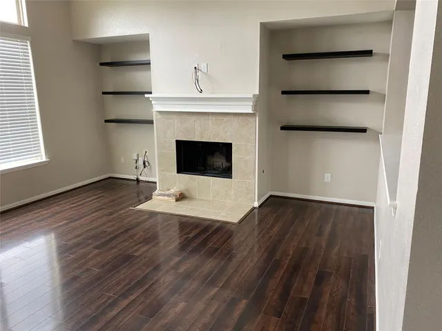a view of a livingroom with a fireplace and window