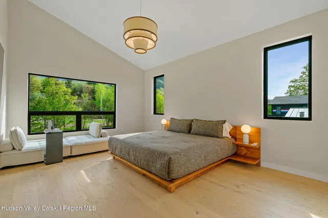 a bedroom with a bed and a large window