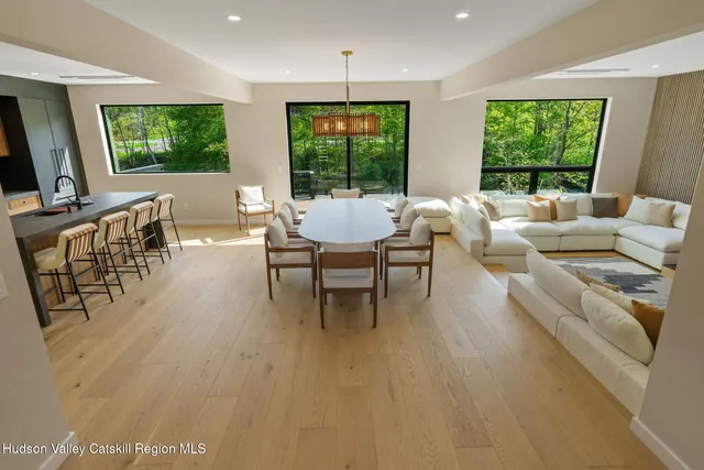 a living room with fireplace furniture and a large window