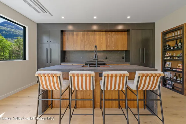 a kitchen with a dining table chairs cabinets and stainless steel appliances
