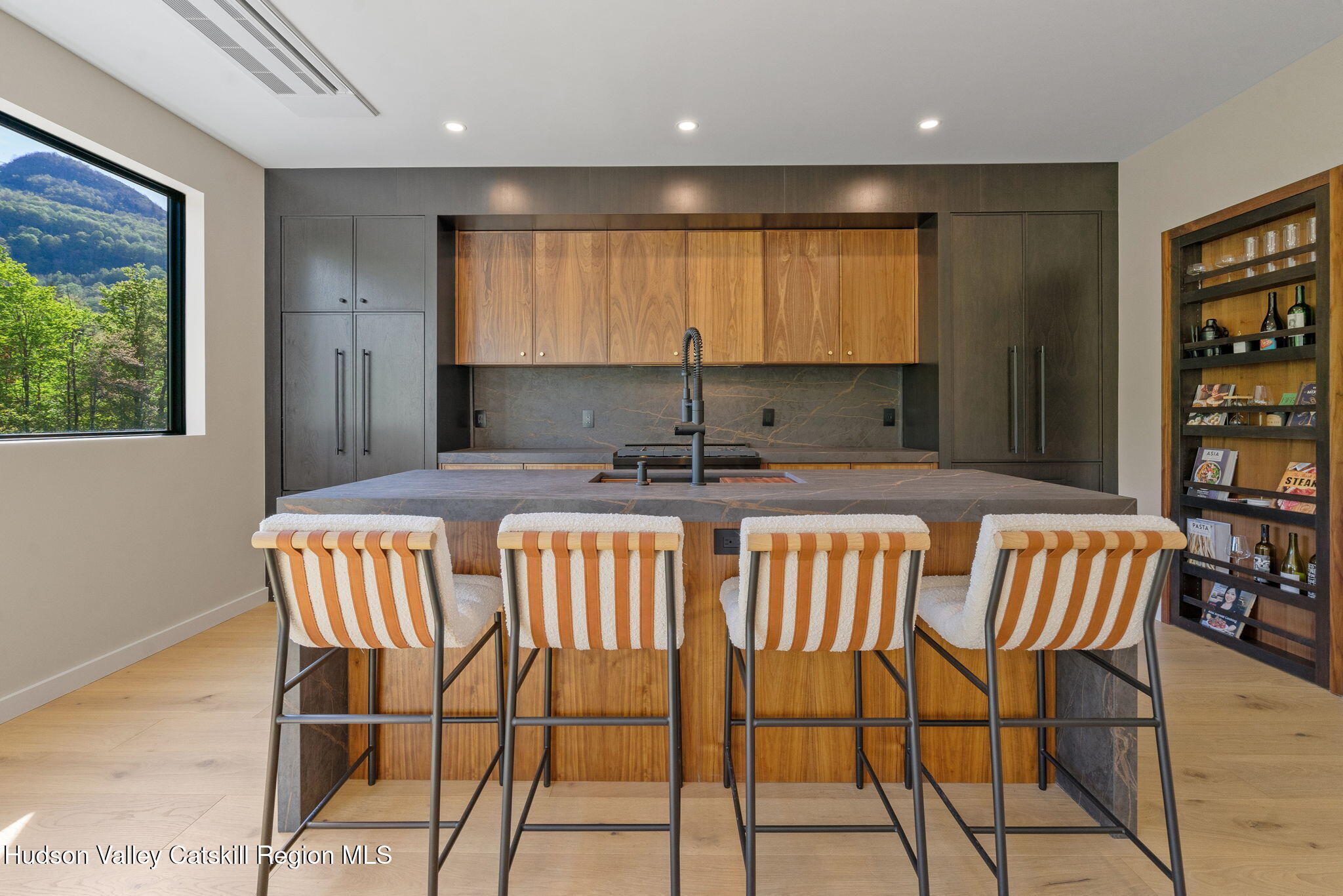 7773 Main Street Hunter, NY 12442 - Photo 8 of 18 a kitchen with a dining table chairs cabinets and stainless steel appliances