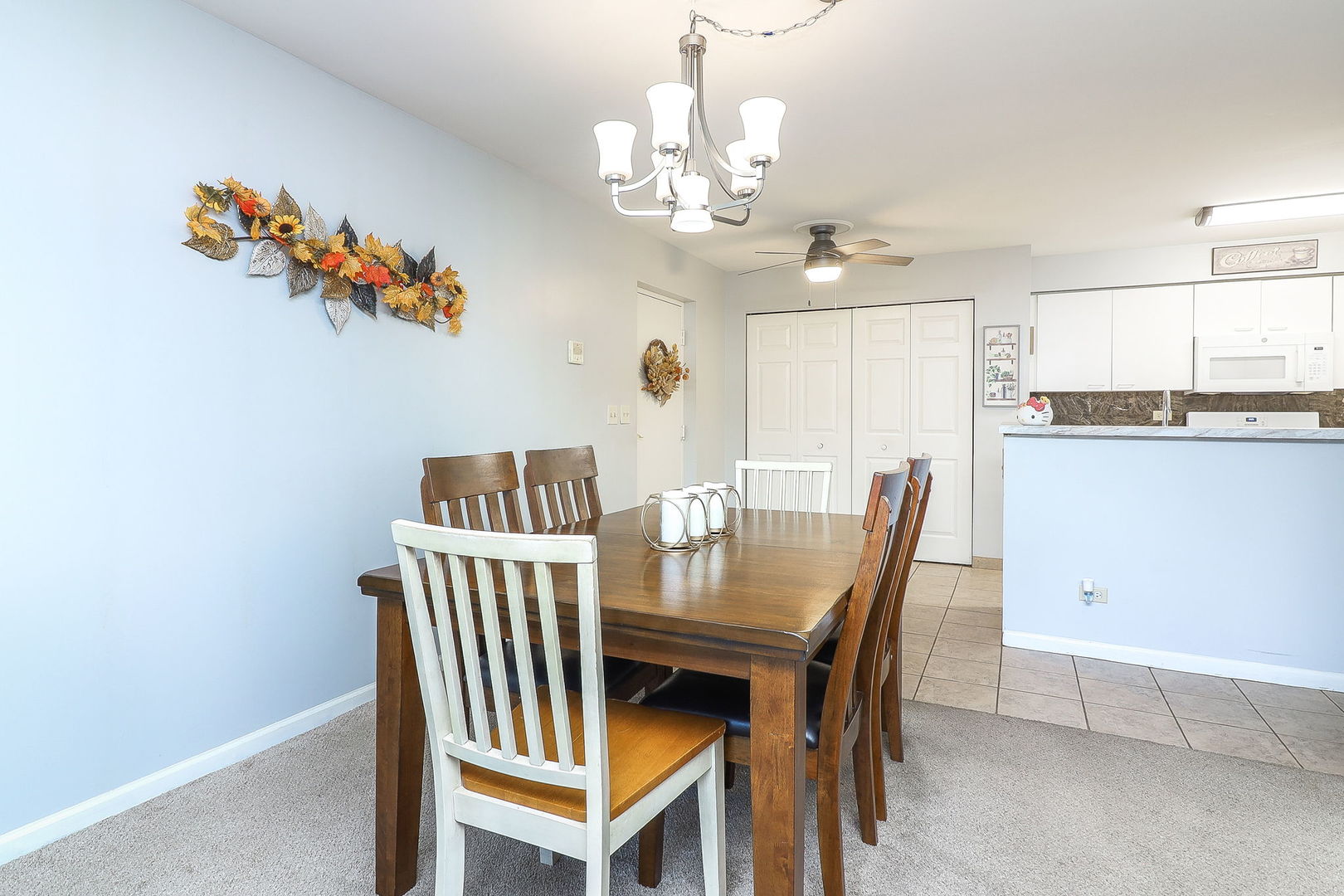 726 North Gary Avenue, Unit 109A Carol Stream, IL 60188 - Photo 6 of 22 a view of a dining room with furniture a chandelier and wooden floor