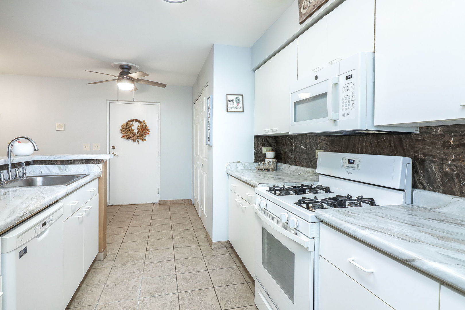 726 North Gary Avenue, Unit 109A Carol Stream, IL 60188 - Photo 9 of 22 a kitchen with granite countertop a sink stove and cabinets