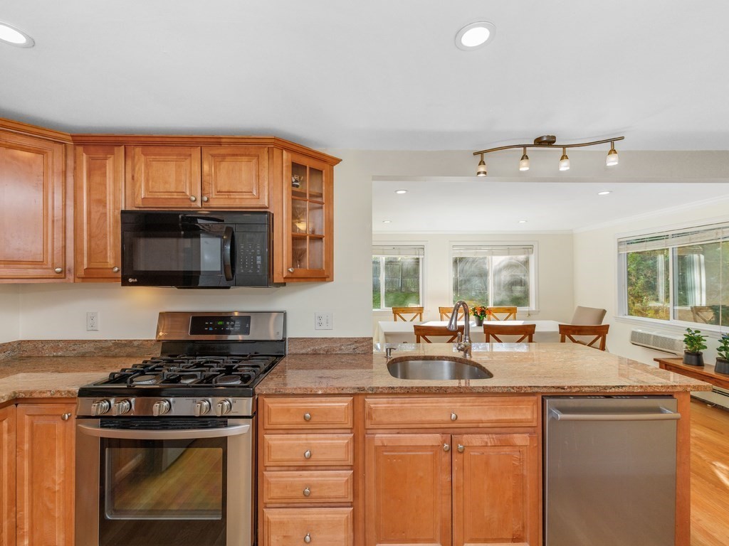 28 Truman Road Newton, MA 02459 - Photo 7 of 26 a kitchen with stainless steel appliances granite countertop a sink stove and microwave