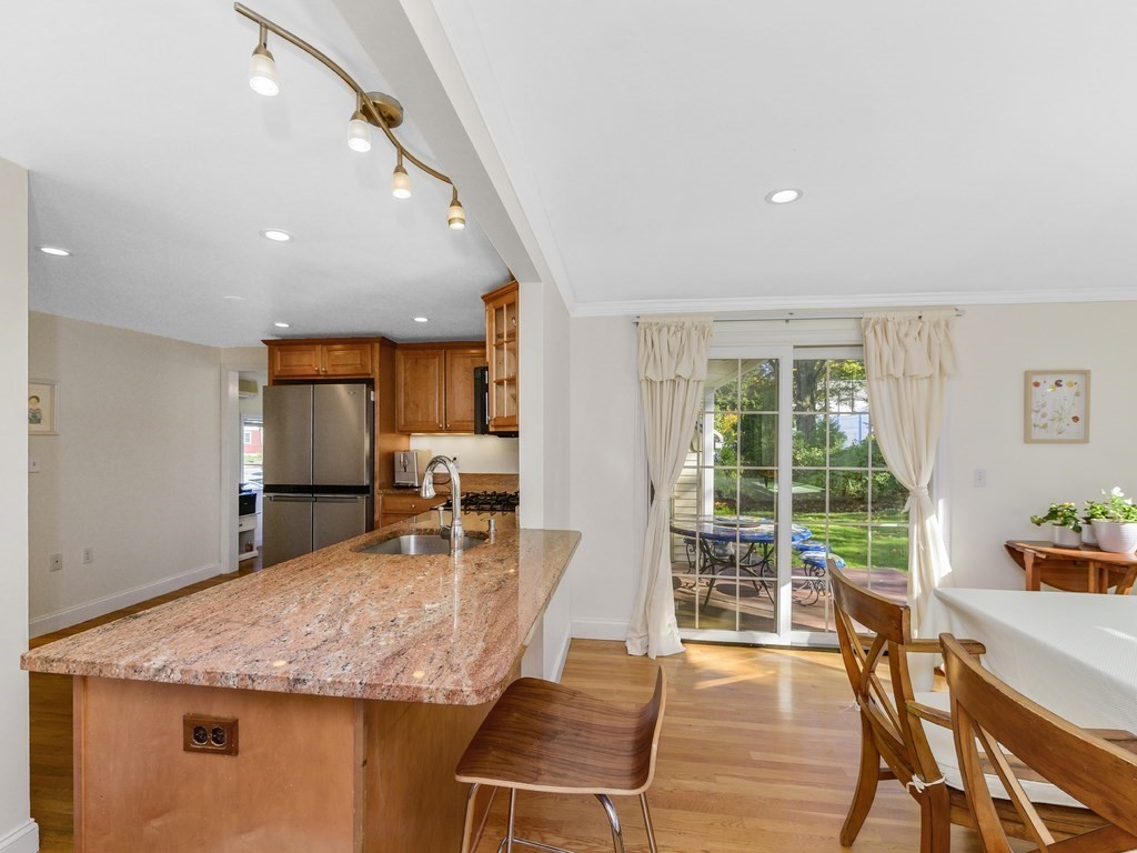 28 Truman Road Newton, MA 02459 - Photo 8 of 26 a dining hall with stainless steel appliances granite countertop a table and chairs with wooden floor