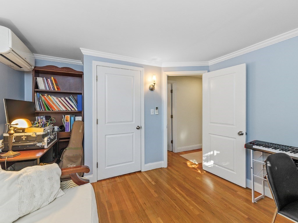 28 Truman Road Newton, MA 02459 - Photo 10 of 26 a bedroom with a bed and a book shelf