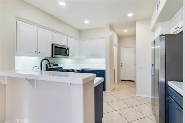 a view of a kitchen with electric appliances