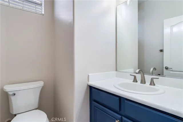 a bathroom with a sink toilet and vanity