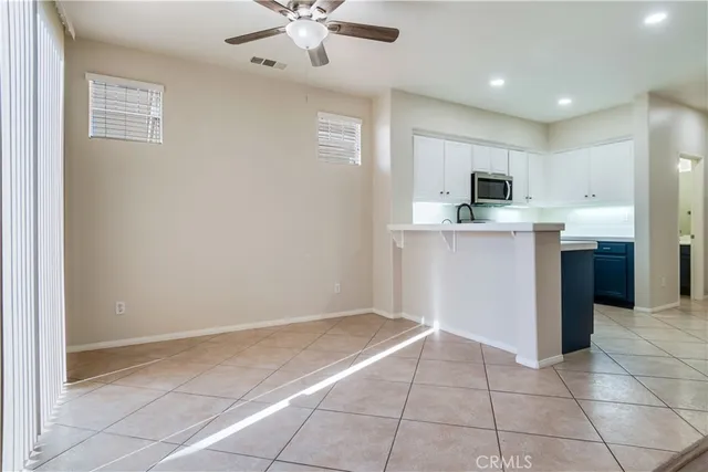a view of kitchen with stainless steel appliances granite countertop a refrigerator and a sink