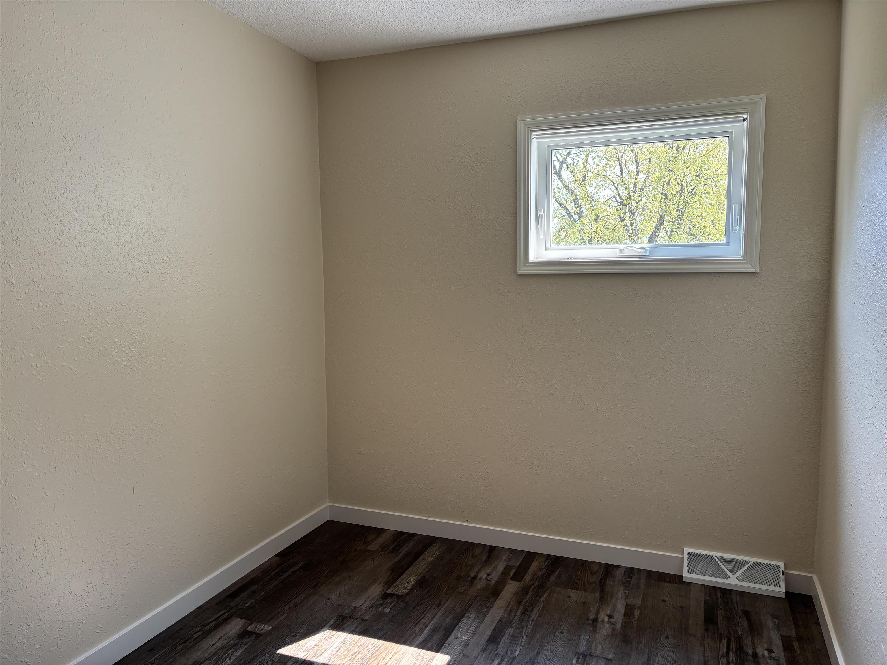 408 Midway Avenue Proctor, MN 55810 - Photo 13 of 20 Unfurnished room with dark wood-style floors and baseboards