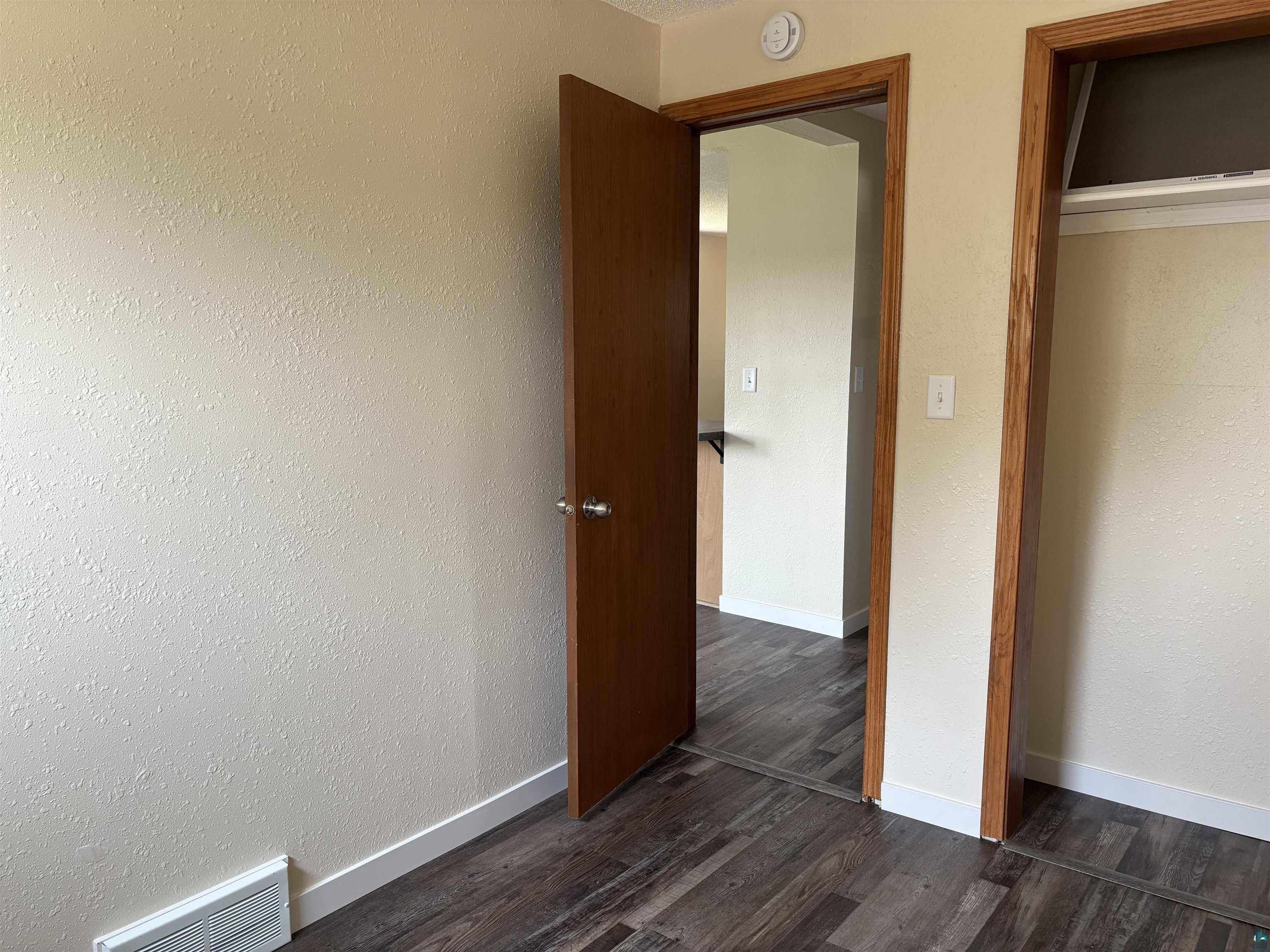 408 Midway Avenue Proctor, MN 55810 - Photo 15 of 20 Unfurnished bedroom with dark wood-type flooring and baseboards