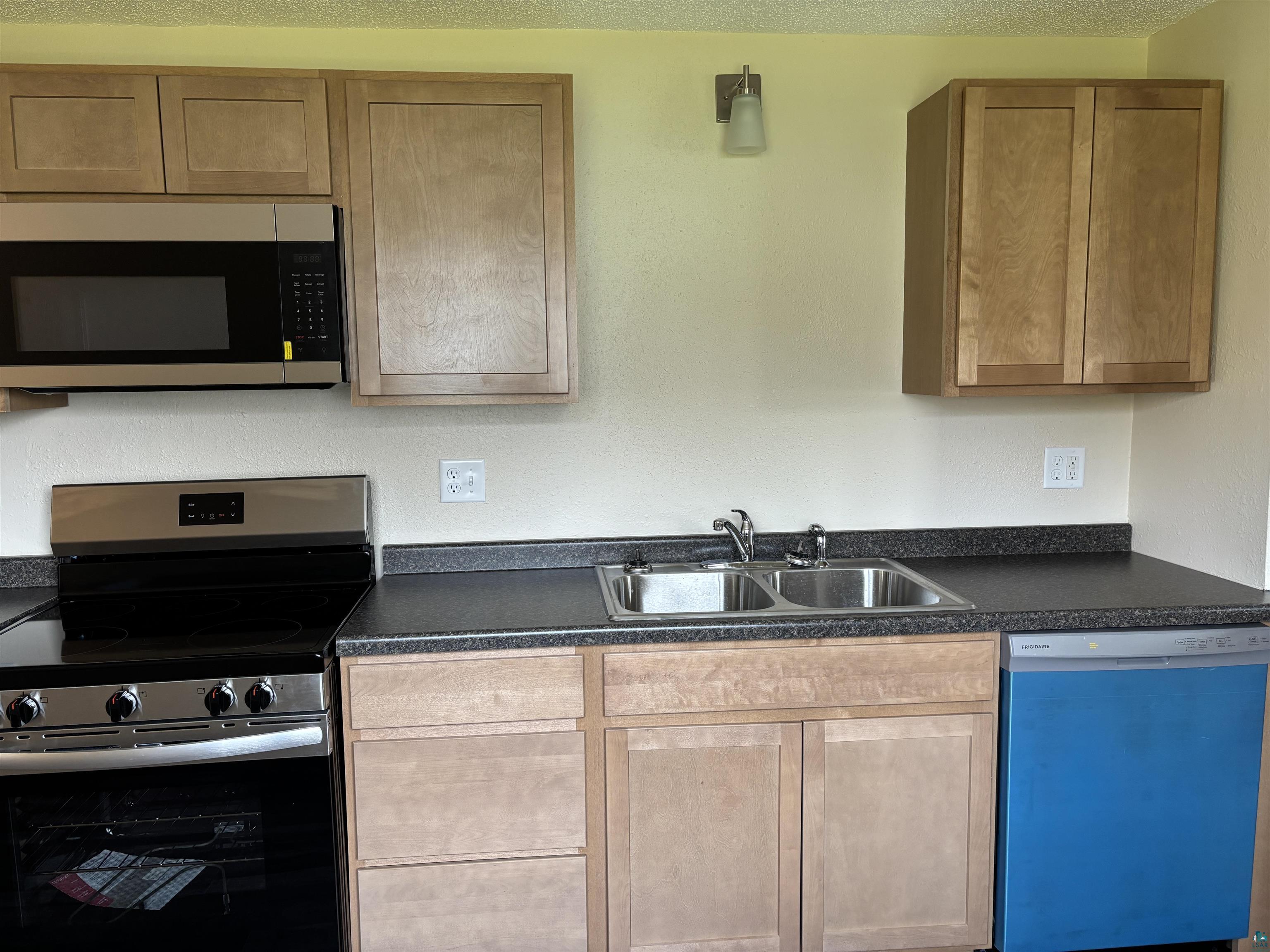 408 Midway Avenue Proctor, MN 55810 - Photo 10 of 20 Kitchen with appliances with stainless steel finishes, a sink, and dark countertops
