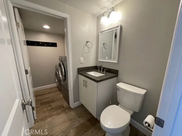 a bathroom with a toilet a sink and a mirror