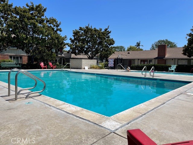 4641 Larwin Avenue Cypress, CA 90630 - Photo 17 of 18 a view of a swimming pool with lawn chairs and a fire pit