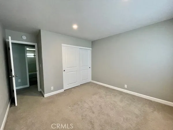 an empty room with closet area