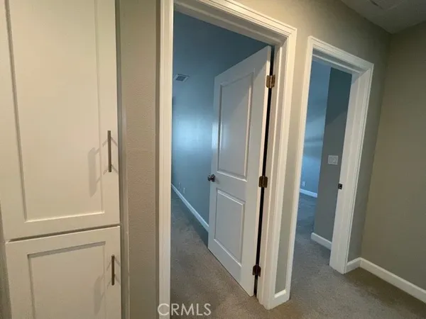 a view of a bathroom from a hallway