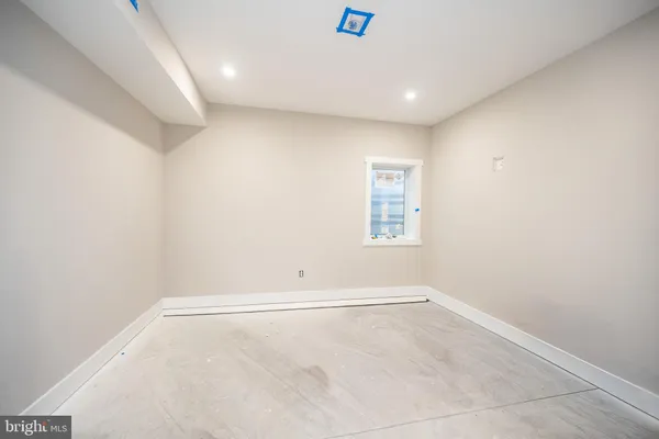 an empty room with closet and a bathroom
