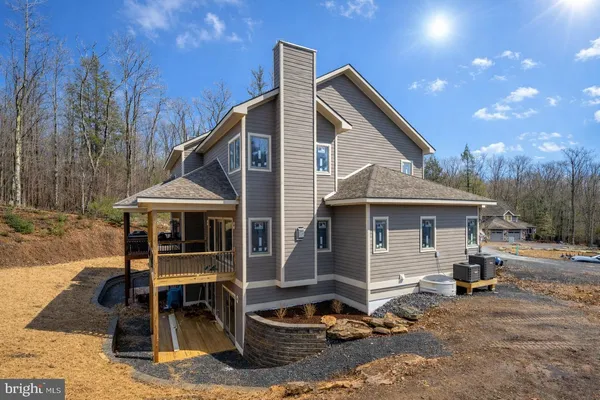 a front view of a house with yard porch and seating