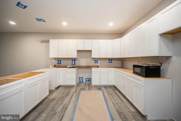a kitchen with white cabinets appliances and a sink