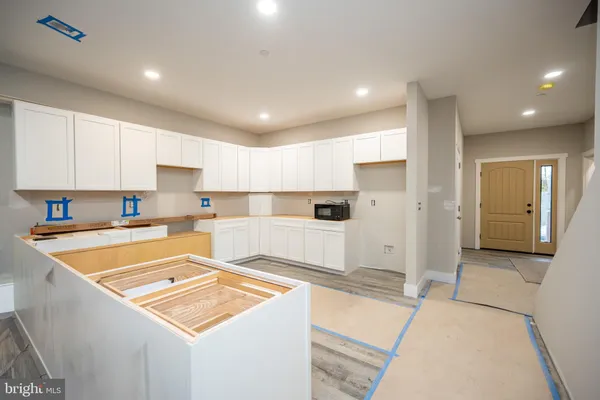 a kitchen with stainless steel appliances granite countertop a sink and a refrigerator