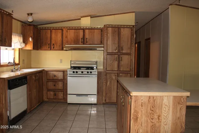 a kitchen with stainless steel appliances a refrigerator and a stove