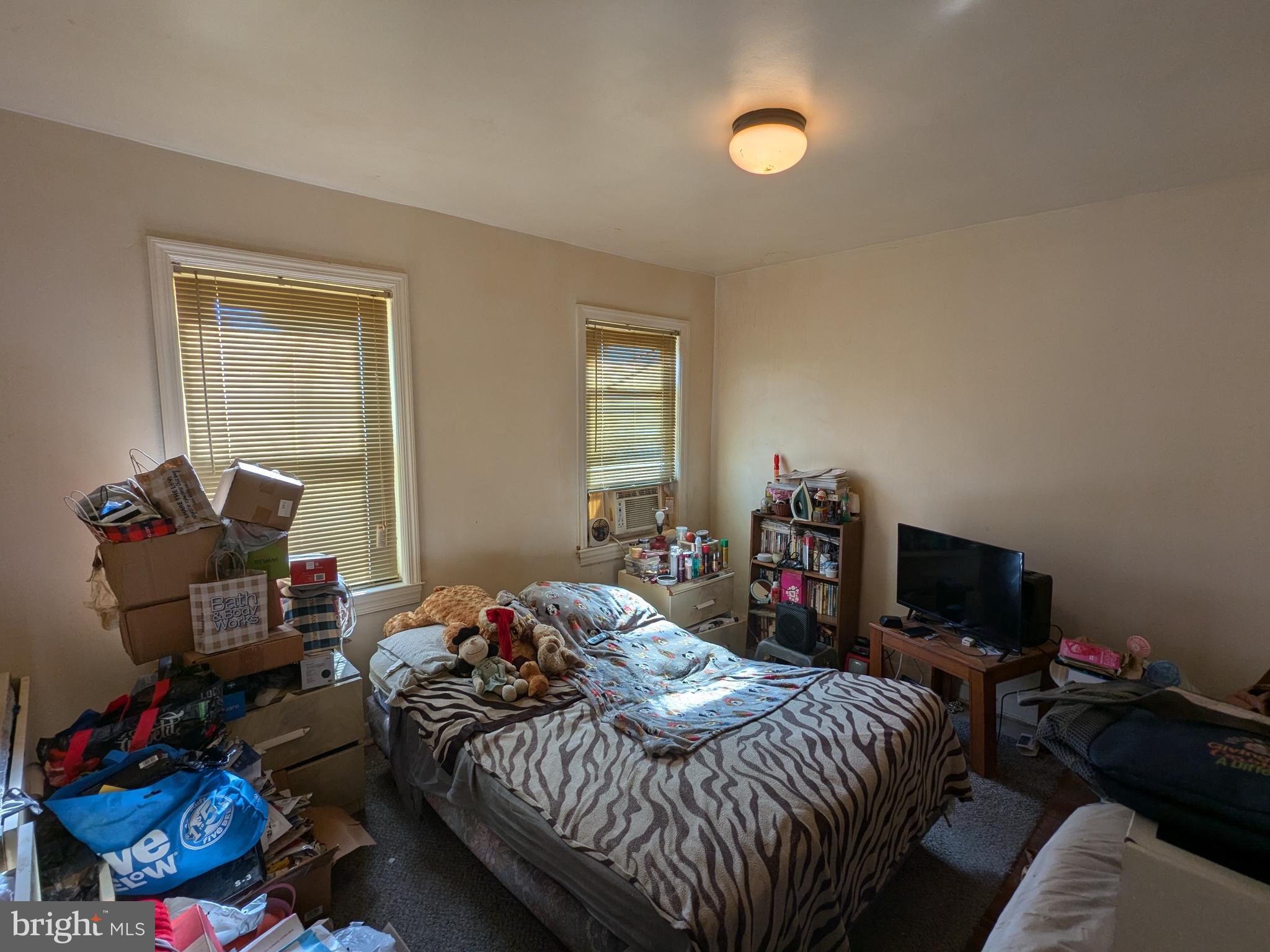 504 Bridgeview Road Baltimore, MD 21225 - Photo 7 of 12 a bedroom with a bed and a tv