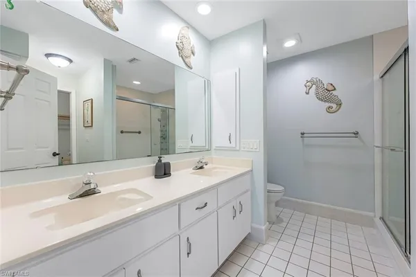 a bathroom with a double vanity sink mirror and double
