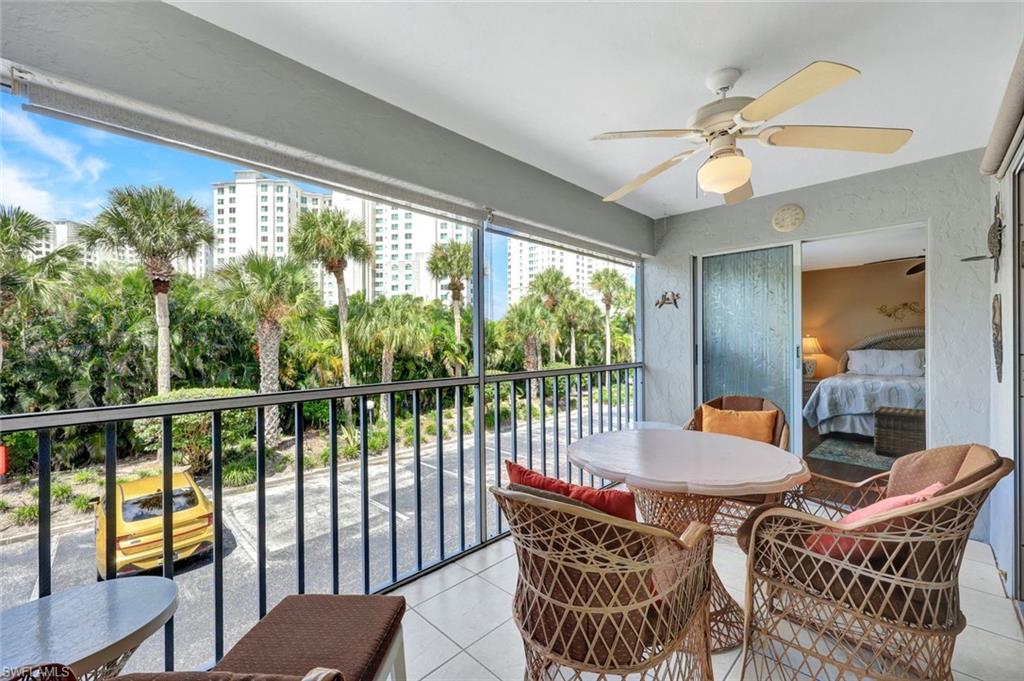 509 Roma Court, Unit 202 Naples, FL 34110 - Photo 16 of 18 Sunroom / solarium with tile patterned floors and a textured wall