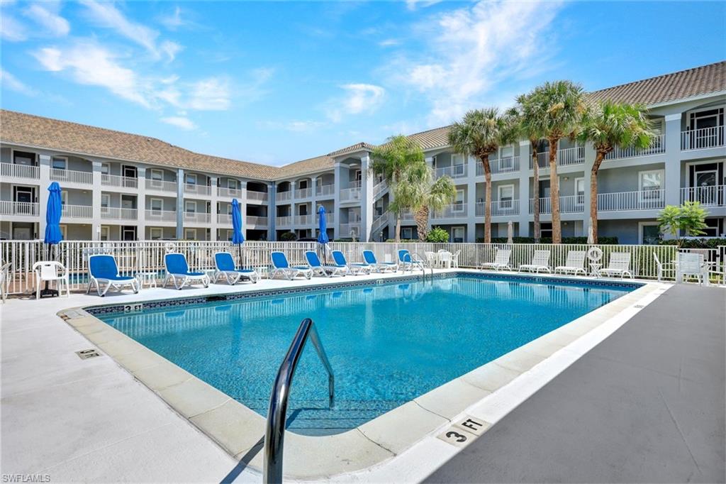 509 Roma Court, Unit 202 Naples, FL 34110 - Photo 17 of 18 Community pool featuring a patio area