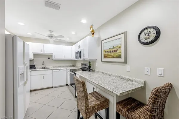 a kitchen with a table and chairs in it