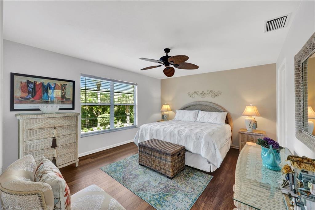 509 Roma Court, Unit 202 Naples, FL 34110 - Photo 9 of 18 Bedroom featuring dark wood-style flooring and a ceiling fan