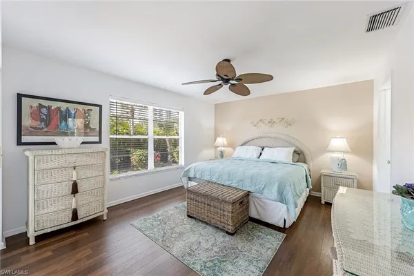 a spacious bedroom with a bed and a window